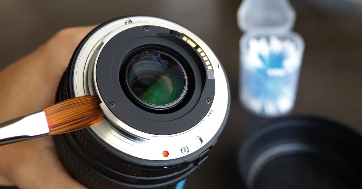 Person Cleaning Camera Lens