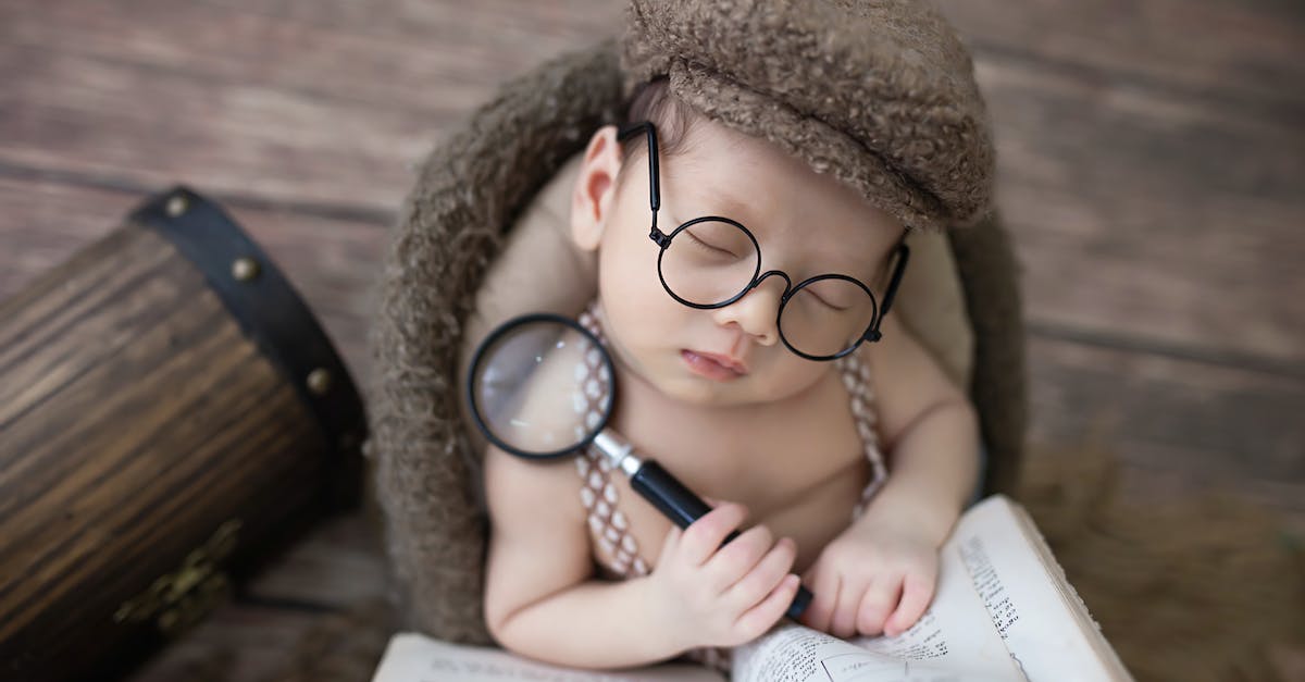 Close-Up Shot of a Baby Boy Holding a Magnifying Glass